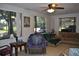 Inviting living room with bright windows, tile flooring and multiple seating areas at 601 W College Ave, Ruskin, FL 33570