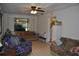 Comfortable living room featuring tile floors, a ceiling fan, and lots of natural light at 601 W College Ave, Ruskin, FL 33570