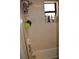 Shower stall featuring tiled walls with a window and toiletry caddy at 601 W College Ave, Ruskin, FL 33570