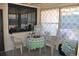 Sunroom with patterned curtains, comfortable seating, and lots of natural light at 601 W College Ave, Ruskin, FL 33570