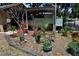 Enclosed outdoor yard with multiple potted plants and an open parking space at 601 W College Ave, Ruskin, FL 33570