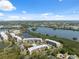 Picturesque aerial view shows community nestled amid lush greenery, tranquil lakes, and blue skies at 6205 Shoreline Dr # 1204, St Petersburg, FL 33708