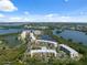 Stunning aerial view showcases the property's prime waterfront location surrounded by lake and lush green landscape at 6205 Shoreline Dr # 1204, St Petersburg, FL 33708