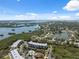 Aerial view of a condominium complex surrounded by lush greenery, with a pool and waterfront access at 6205 Shoreline Dr # 1204, St Petersburg, FL 33708