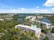 Scenic aerial view shows a well-maintained condo with lush landscaping, pool, and views of surrounding waterways at 6205 Shoreline Dr # 1204, St Petersburg, FL 33708