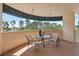 Cozy balcony with seating, offering a relaxing outdoor space with a view of lush green trees at 6205 Shoreline Dr # 1204, St Petersburg, FL 33708