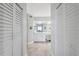Hallway view of the main bathroom featuring an elegant vanity with white cabinetry at 6205 Shoreline Dr # 1204, St Petersburg, FL 33708