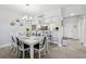 Bright dining area with modern light fixture and seating for eight, open to the kitchen at 6205 Shoreline Dr # 1204, St Petersburg, FL 33708