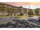 Beautiful condo with lush landscaping, mature trees, and inviting entrance, creating a welcoming curb appeal at 6205 Shoreline Dr # 1204, St Petersburg, FL 33708