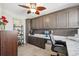 Comfortable home office with custom cabinetry, marble countertop and a decorative ceiling fan at 6205 Shoreline Dr # 1204, St Petersburg, FL 33708