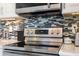 Modern stainless steel range against a stylish backsplash, complemented by white cabinetry and countertops at 6205 Shoreline Dr # 1204, St Petersburg, FL 33708