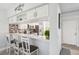 Kitchen area with bar seating, white cabinets, modern appliances, and decorative accents, providing a functional and stylish space at 6205 Shoreline Dr # 1204, St Petersburg, FL 33708