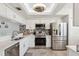 Modern kitchen featuring stainless steel appliances, white cabinets, and stylish backsplash at 6205 Shoreline Dr # 1204, St Petersburg, FL 33708