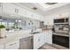 Modern kitchen with stainless steel appliances and a view into the bright living room at 6205 Shoreline Dr # 1204, St Petersburg, FL 33708
