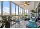 Screened lanai with comfortable seating, plants, and panoramic views at 6205 Shoreline Dr # 1204, St Petersburg, FL 33708