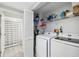 Functional laundry room with modern washer and dryer, storage shelves and accessories at 6205 Shoreline Dr # 1204, St Petersburg, FL 33708