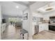 Bright living area with tile floors, a large window, and white cabinets adjacent to a kitchen with stainless appliances at 6205 Shoreline Dr # 1204, St Petersburg, FL 33708