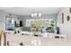 Bright living room with water views, large windows, comfortable seating, and a dining area with quartz countertop at 6205 Shoreline Dr # 1204, St Petersburg, FL 33708