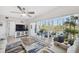 Cozy living room featuring a ceiling fan, sliding glass doors to a balcony with furniture, offering a relaxing indoor-outdoor flow at 6205 Shoreline Dr # 1204, St Petersburg, FL 33708