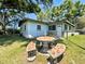 Backyard patio area with mosaic table and seating, perfect for outdoor dining at 6350 55Th N Ave, St Petersburg, FL 33709