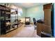 Inviting bedroom area, featuring a decorative bookcase, chair, and work area with an office chair at 6350 55Th N Ave, St Petersburg, FL 33709