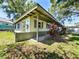 Side exterior view featuring landscaping and hose hookup at 6350 55Th N Ave, St Petersburg, FL 33709