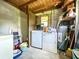 Practical laundry room with washer, dryer, and additional storage space, plus a utility sink at 6350 55Th N Ave, St Petersburg, FL 33709