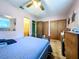 Relaxing main bedroom with classic bed frame, ceiling fan, and access to an ensuite bathroom at 6350 55Th N Ave, St Petersburg, FL 33709