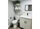 Cozy bathroom showcasing a toilet, vanity with storage, shelves and a mirror for added convenience at 6401 30Th N Way, St Petersburg, FL 33702