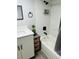 Well-lit bathroom featuring a tub-shower combination, updated hardware, and ample storage at 6401 30Th N Way, St Petersburg, FL 33702