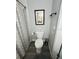 Clean bathroom with a toilet, shower, and palm tree art on the wall at 6401 30Th N Way, St Petersburg, FL 33702