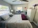 Bright bedroom featuring a comfortable bed, sleek ceiling fan, and ample natural light from a large window at 6401 30Th N Way, St Petersburg, FL 33702