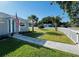 Charming home with a lush lawn, flag, and a white picket fence at 6401 30Th N Way, St Petersburg, FL 33702
