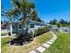 Well-maintained home featuring lush landscaping and a charming stone pathway to the front door at 6401 30Th N Way, St Petersburg, FL 33702