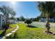 Manicured front yard with a stone path and mature palm trees at 6401 30Th N Way, St Petersburg, FL 33702