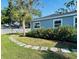Charming front yard with lush green grass, a stepping stone path, and flowering bushes at 6401 30Th N Way, St Petersburg, FL 33702