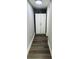 Narrow hallway featuring durable wood-look floors and a tall white storage cabinet, ideal for maximizing space at 6401 30Th N Way, St Petersburg, FL 33702
