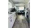 Modern kitchen open to the living area, featuring stainless steel appliances and white cabinets at 6401 30Th N Way, St Petersburg, FL 33702