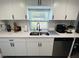 Bright kitchen featuring stylish countertops, updated appliances, and ample cabinet space at 6401 30Th N Way, St Petersburg, FL 33702