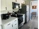 Bright kitchen with white cabinets, stainless steel appliances, and stylish countertops at 6401 30Th N Way, St Petersburg, FL 33702