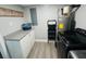 Functional laundry room with washer, dryer, storage cabinets, and modern water heater at 6401 30Th N Way, St Petersburg, FL 33702