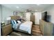 Bright main bedroom with stylish wood-look flooring, modern furnishings, and ample storage with multiple dressers at 6401 30Th N Way, St Petersburg, FL 33702