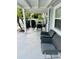 Covered porch with outdoor table and chairs, and two comfortable chairs at 6401 30Th N Way, St Petersburg, FL 33702