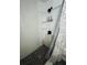 Bright, modern shower with black fixtures, tile floor, and soap dispensers at 6401 30Th N Way, St Petersburg, FL 33702