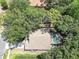 Aerial view of a home with a screened-in pool surrounded by lush landscaping at 6410 Beaver Way, Tampa, FL 33625