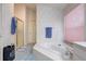 Bathroom featuring a soaking tub, glass shower, and blue tile flooring at 6410 Beaver Way, Tampa, FL 33625