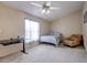 Bedroom with vaulted ceiling, ceiling fan, bed, desk, and comfortable armchair at 6410 Beaver Way, Tampa, FL 33625