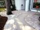 Inviting front entrance with a beautiful curved walkway, landscaped with brick pavers, and a decorative birdhouse hanging from a tree at 6410 Beaver Way, Tampa, FL 33625