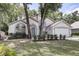 Charming single Gathering home featuring mature trees and a well maintained front yard at 6410 Beaver Way, Tampa, FL 33625