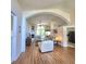 Open concept living room featuring hardwood floors, fireplace, and open archway to kitchen at 6410 Beaver Way, Tampa, FL 33625